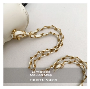 Detailed close-up of premium white leather handbag strap with gold metal chain link