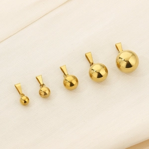 Detailed view of five graduated sizes of golden stainless steel ball pendant charms