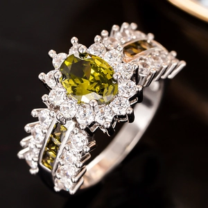 Detailaufnahme eines ovalen olivgrünen Edelsteinrings mit Diamant-Pavé-Einfassung