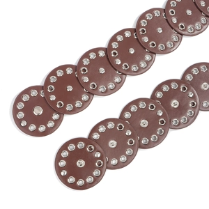 Detail of brown leather belt with overlapping circles and silver metal rivets