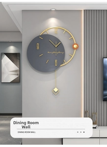 Detail view of modern grey and gold wall clock with silent mechanism and geometric pendulum