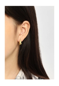 Close-up of minimalist U-shaped golden drop earring worn on ear with metallic shine