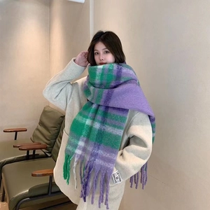 Detailed view of checkered mohair scarf with fringe and handmade pashmina label