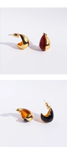 Detail view of retro teardrop earrings with enamel finish in red black and gold