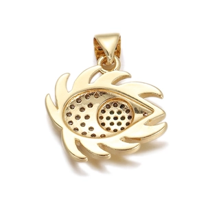Macro shot of gold-plated evil eye pendant detail with intricate back cavity design