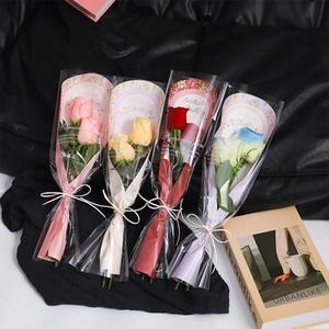 Close-up of artificial soap flower bouquets in pink yellow red and blue with silk ribbons