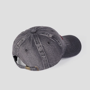 Close-up of adjustable metal buckle and washed denim texture on vintage baseball cap