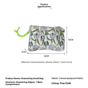 Detail view of floral jacquard pouch with green drawstring and yellow zipper, 16x10x2cm