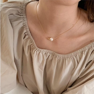 Elegant 925 sterling silver pearl necklace with gold chain shown on a model's neck