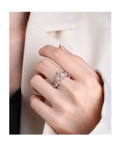 Detail of silver double layer cross rings with zircon stones worn by a model