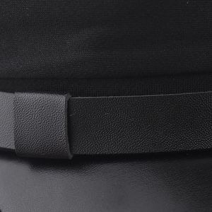 Close-up of the black fabric military hat with a sleek faux leather strap and buckle detail