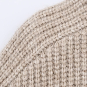 Gros plan détaillé sur la texture en maille beige et le tissu en laine mélangée