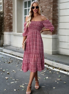 Close-up of red floral off-shoulder dress with elastic smocking and puff sleeves