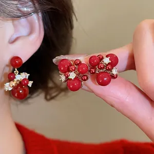 Elegant gold plated silver needle red zircon firework earrings for New Year festivities