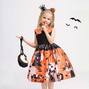 Detail of Halloween witch dress with pumpkin prints, spooky castle motifs and headband