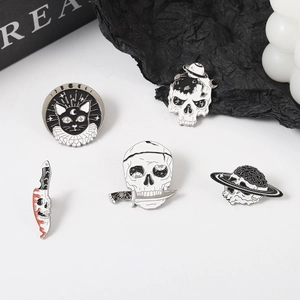 Five-piece set of black and white skull enamel pins featuring cat and planetary designs