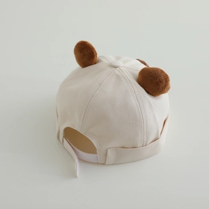Cute off-white baby docker hat with small brown bear ears for kids aged 2 to 4