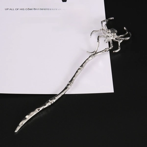 Vintage silver metal hair stick featuring a unique spider skull design and textured body