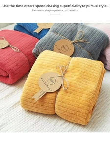 Detailed texture of colorful ribbed coral fleece bath towels with rustic rope packaging