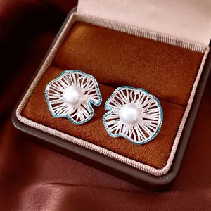 Silver needle flower earrings with pearl and blue oil drip in a velvet jewelry gift box