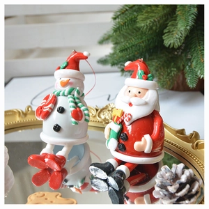 Detail of 3D Santa and snowman polymer clay ornaments on a decorative gold tray