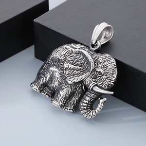 Detailed close-up of a silver elephant pendant with oxidized vintage texture and crystal accents