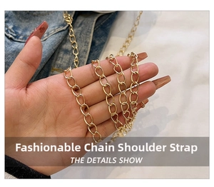 Detail of a shiny gold flat oval link metal chain strap for stylish cross-body bags