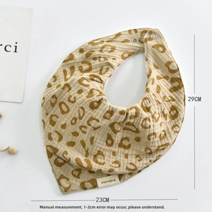 Detail of baby cotton bib featuring leopard print with adjustable snaps and size info