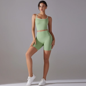 Detail view of avocado green yoga set featuring high-waist shorts and contrast trim sports bra