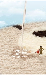 Close-up of thick absorbent cartoon bath mat showing high water absorption with model