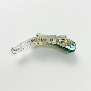 Detail of floral banana clip with inlaid rhinestones and green gradient shell finish