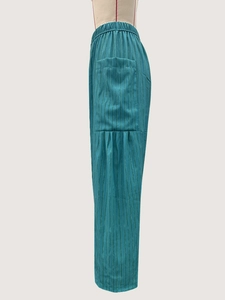 Detailed side view of turquoise striped straight-leg pants with large cargo pocket