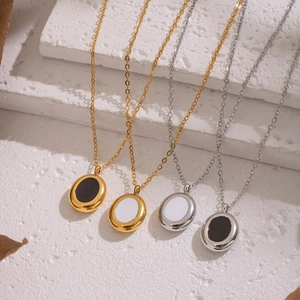 Elegant gold and silver oval necklaces with black and white enamel inlays on white stone