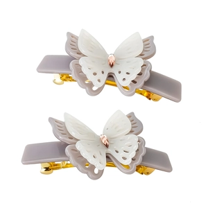 Detail of layered double-butterfly hair claw clip with gradient acrylic and gold metal base