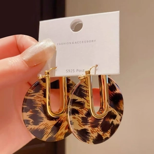 Close-up of leopard print resin earrings with golden metal and S925 silver posts