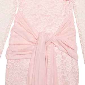 Close-up of pink lace dress waist featuring a soft mesh belt with a delicate knot detail