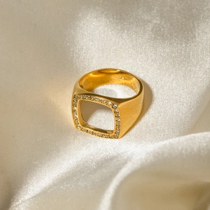 Close-up of a 18k gold plated hollow square ring with sparkling diamond inlay