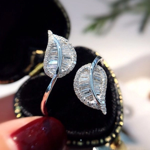 Detail of silver leaf hoop earrings with clear cubic zirconia in a heart-shaped box