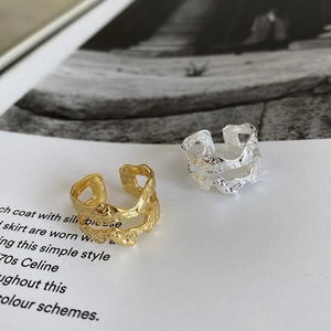 Macro detail of gold and silver irregular textured double-layer adjustable rings