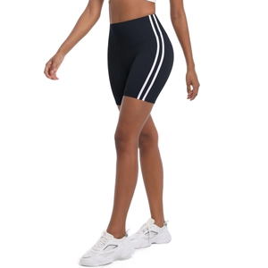 Detail of high-waisted yoga shorts with side stripes and slim fit design on model