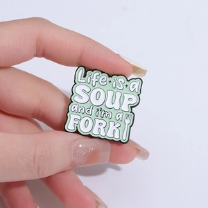 Mint green enamel brooch with humorous 'Life is a SOUP and i'm a FORK' slogan