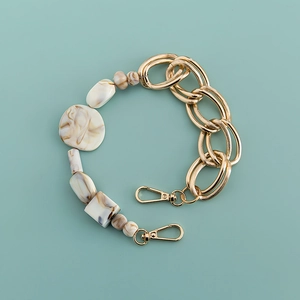 Detail of marble pattern acrylic links combined with gold metal chain and lobster clasps