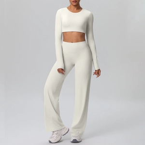 Detail view of the long-sleeved crop top and high-waisted flared pants sports set