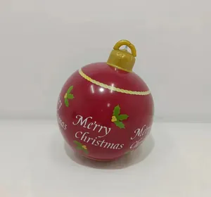 Detail of red inflatable Christmas ball featuring Merry Christmas print and golden hook