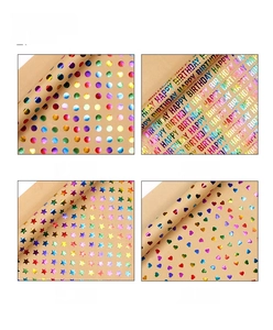 Detail of kraft paper gift wrap featuring rainbow foil dots, stars, hearts and lettering