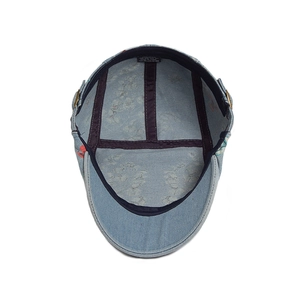 Interior detail of washed denim ivy cap featuring floral print lining and cotton material