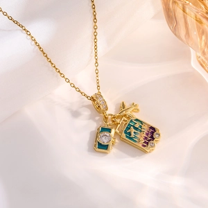 Macro view of gold camera, airplane, and purple suitcase pendants on silk background