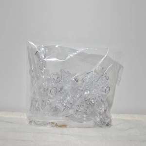 Detailed view of clear acrylic snowflake and icicle ornaments in bulk packaging