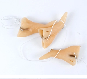 Detailed view of flesh-colored Halloween witch nose props with white elastic straps