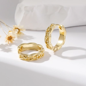 Elegant gold hollow woven hoop earrings with cross texture in a professional still life view